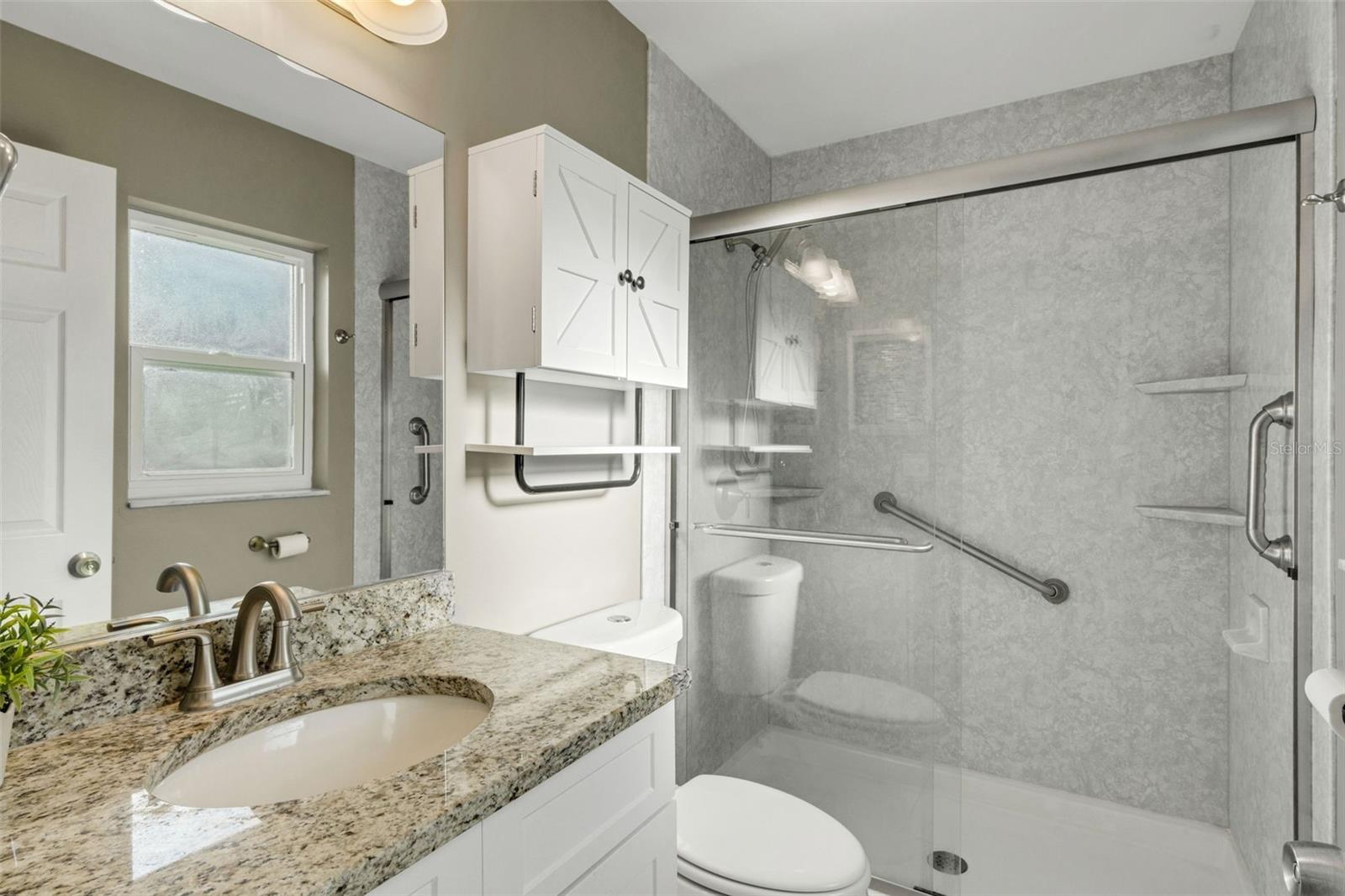 Updated walk in shower, updated vanity with granite and window for natural light.