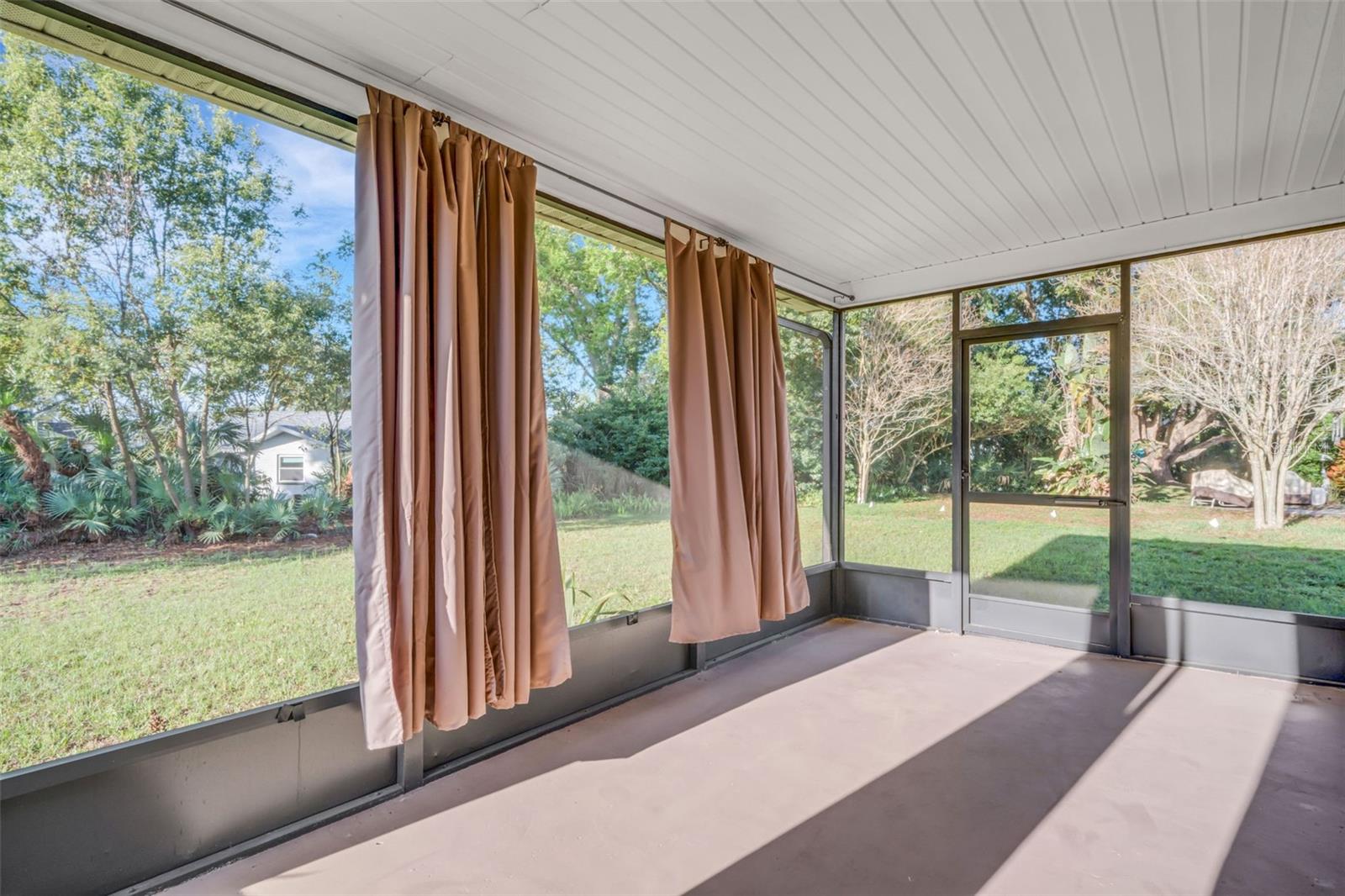 Screened in Florida Room with huge yard.