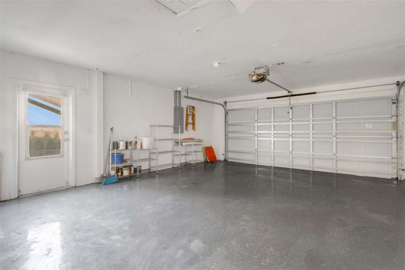 Large 2 car garage with pedestrian door, with epoxy paint