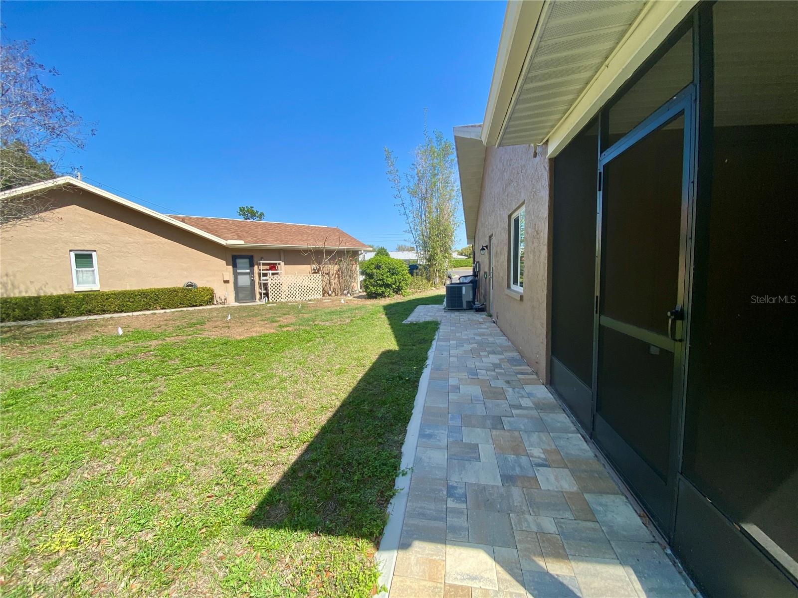 Pavers wrap around to the front door.