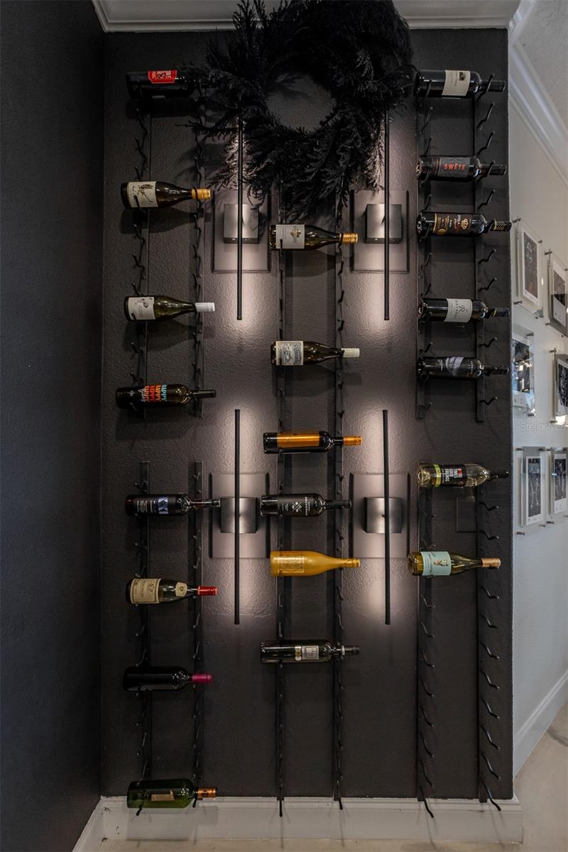 Architectural wine display wall on a dark accent finish, perfect for collectors.