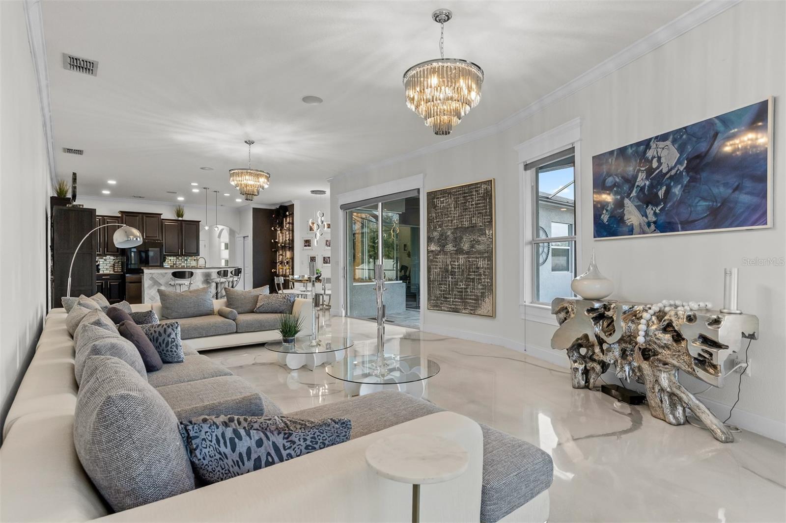 View from the main living room looking toward the open kitchen and breakfast bar.