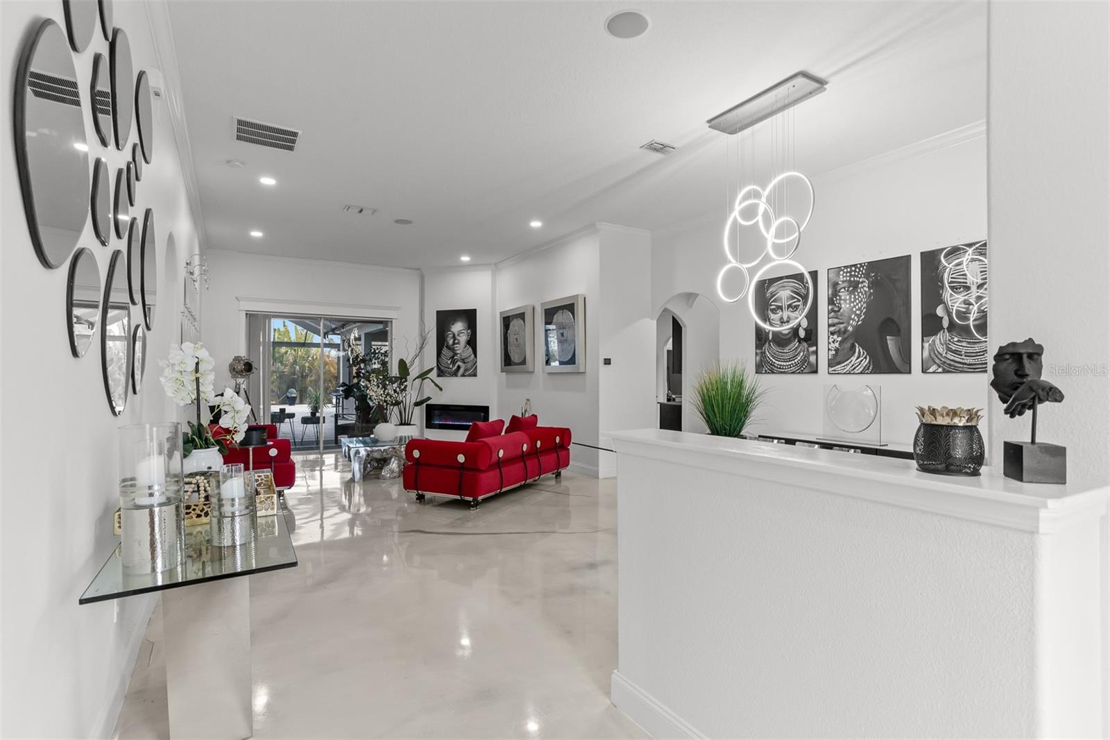 Wide-angle view showing the seamless flow between the entry, dining, and main living areas.