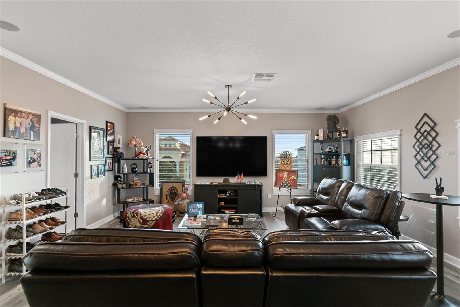 Panoramic view of the upstairs bonus room showing the media console and ceiling detail.