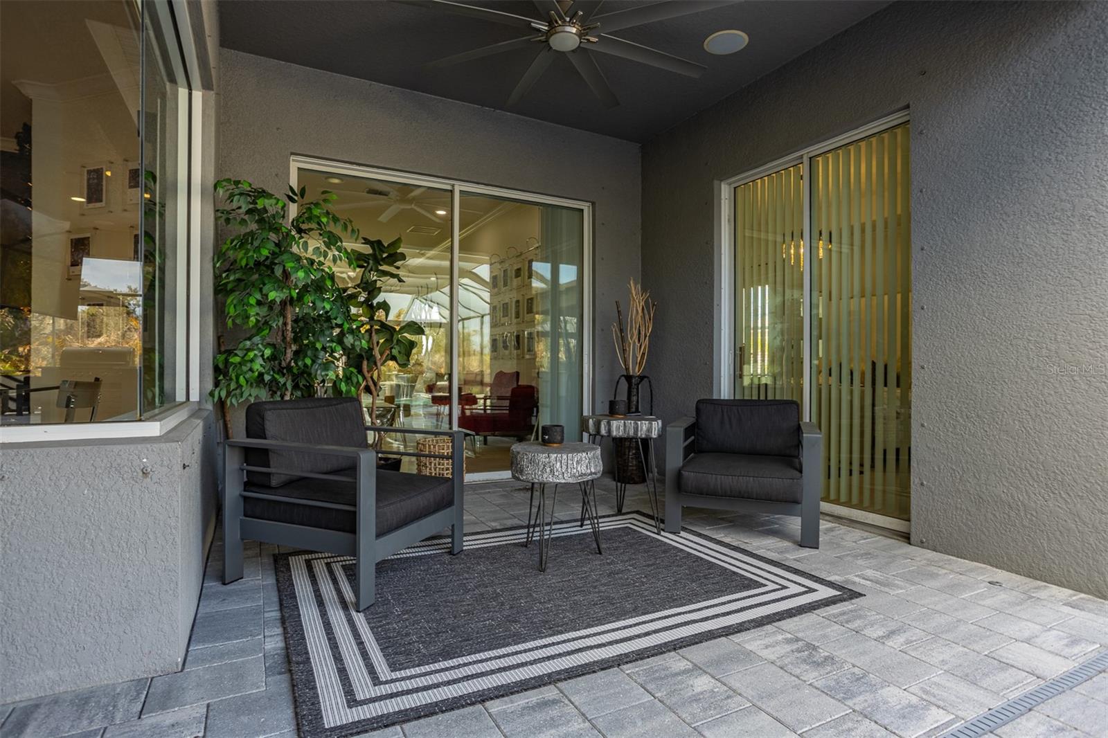 Close-up of the shaded outdoor lounge area looking into the home's interior.