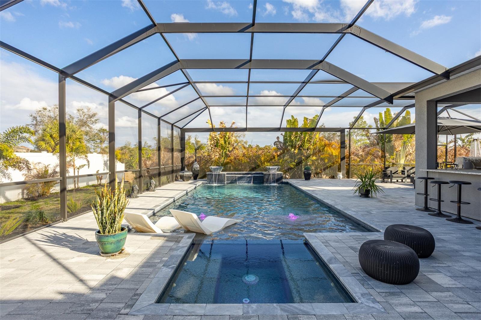 Elevated view of the custom swimming pool with integrated spa and decorative water bowls.