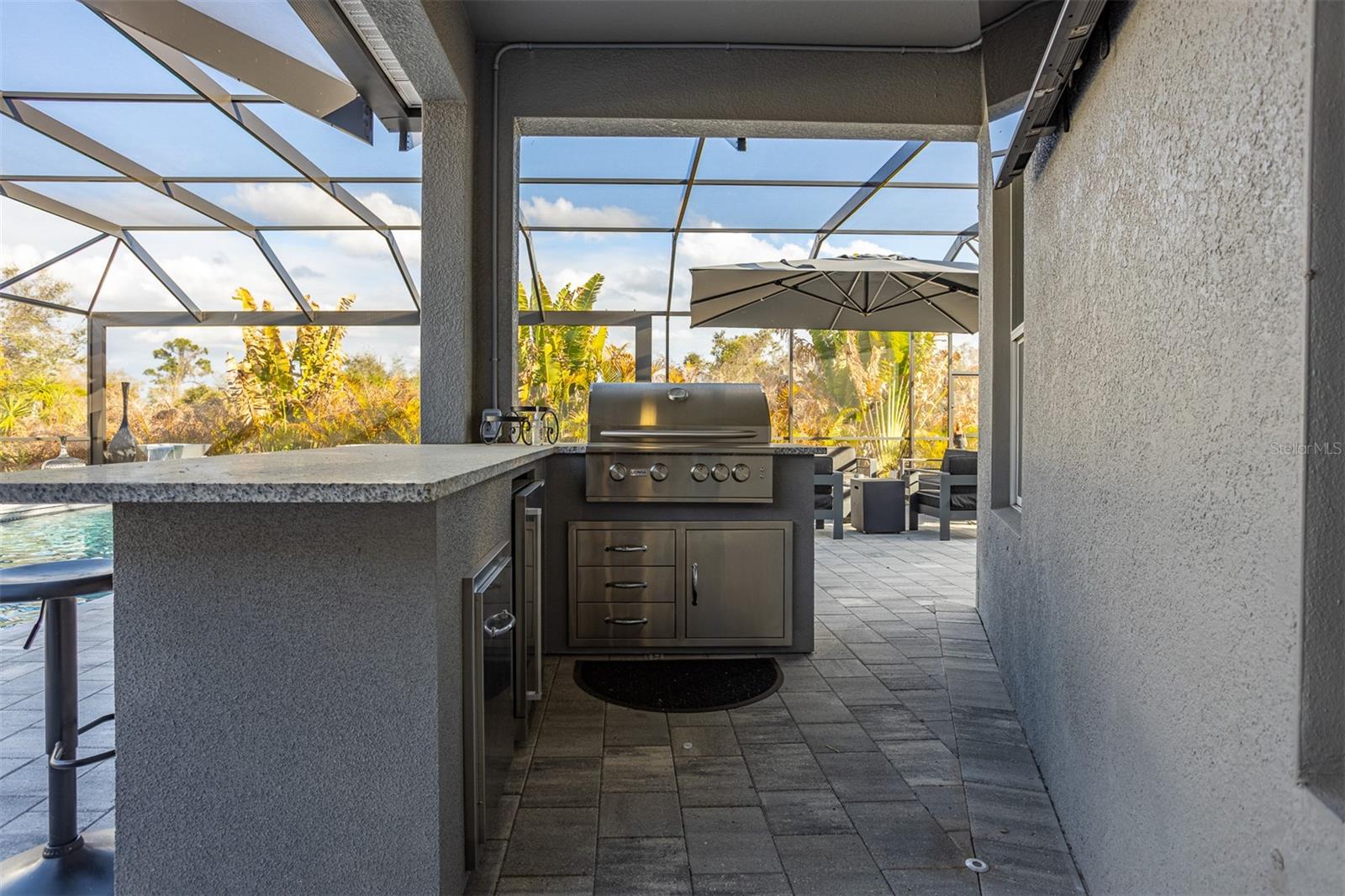 Built-in stainless steel professional grill with storage drawers and prep area.