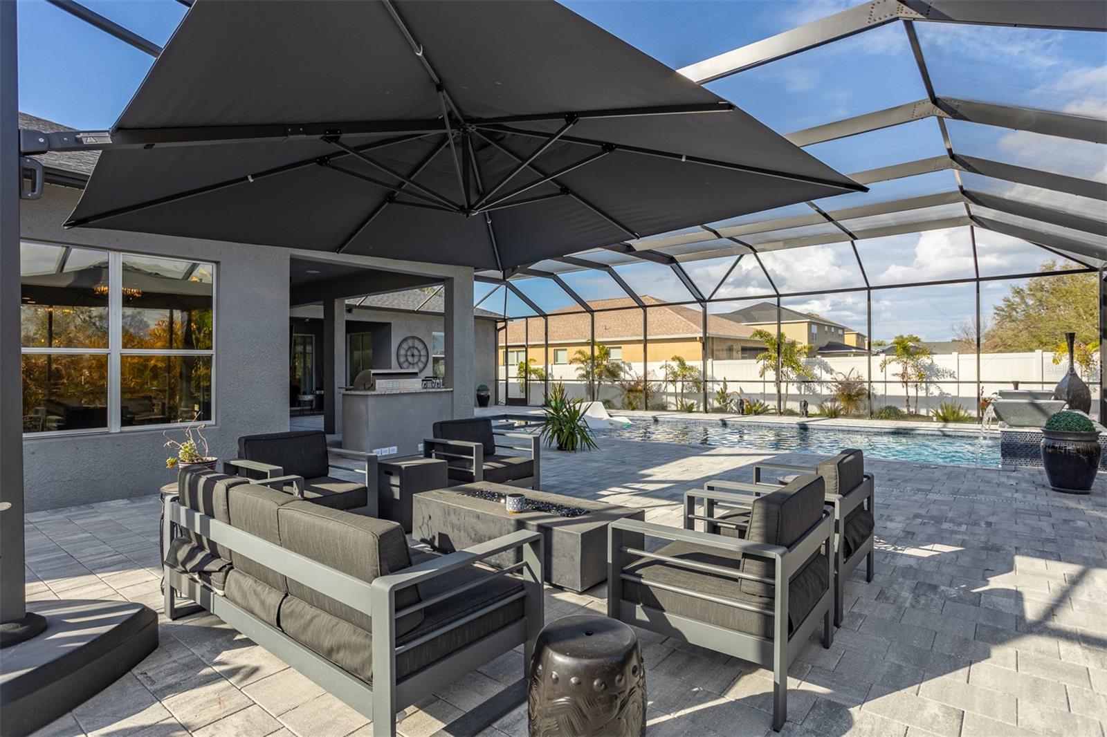 Lanai view featuring the outdoor kitchen and shade umbrella.