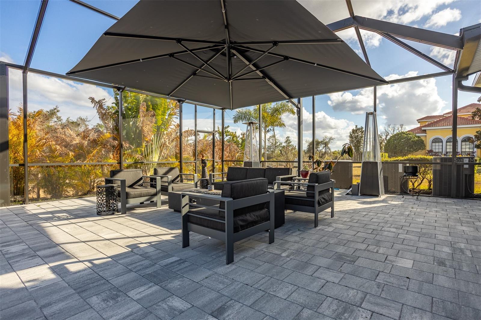 Full view of the paved patio entertainment suite with private tropical views.