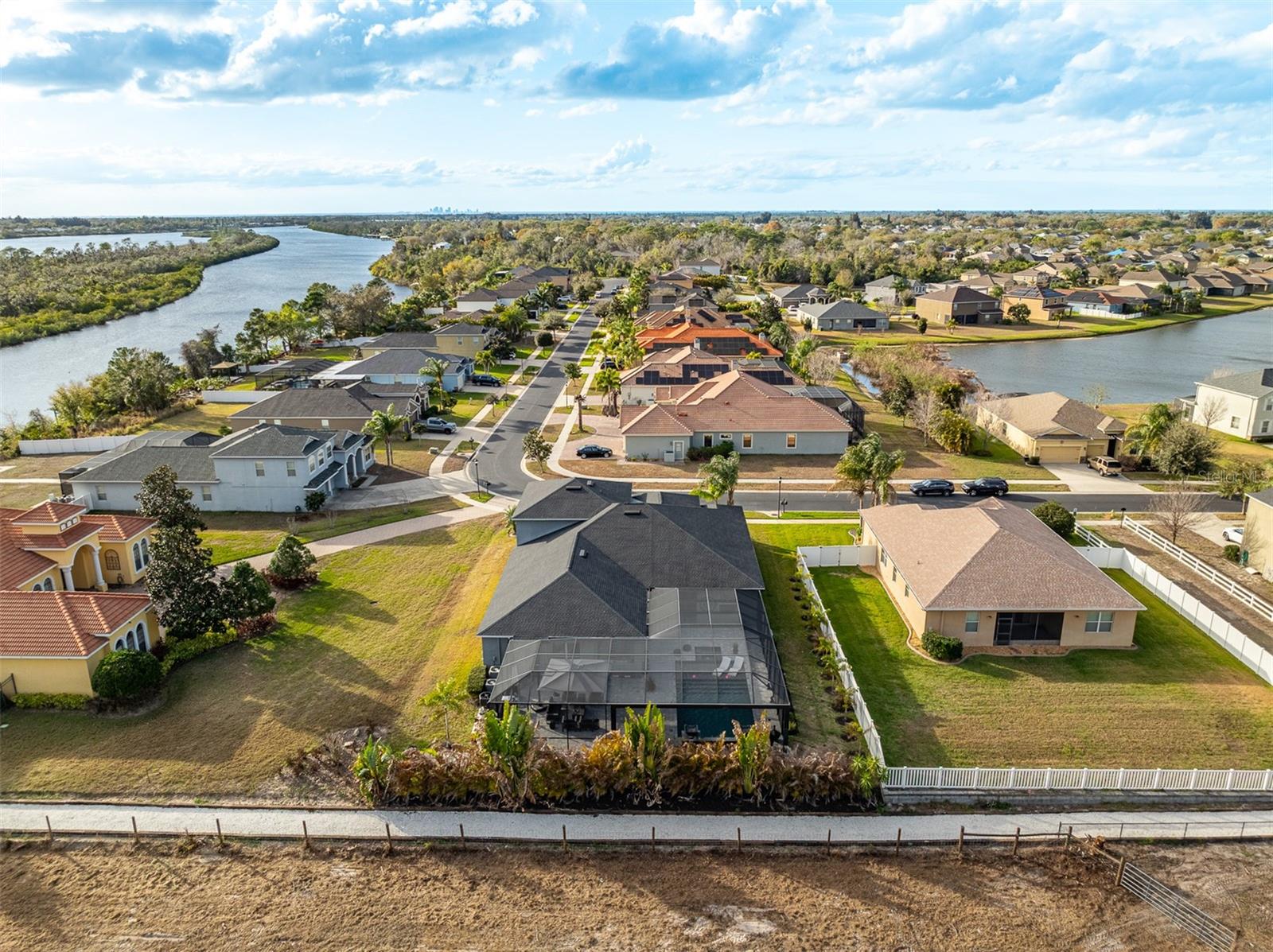 Wide shot showing the property in relation to the community pond and river.