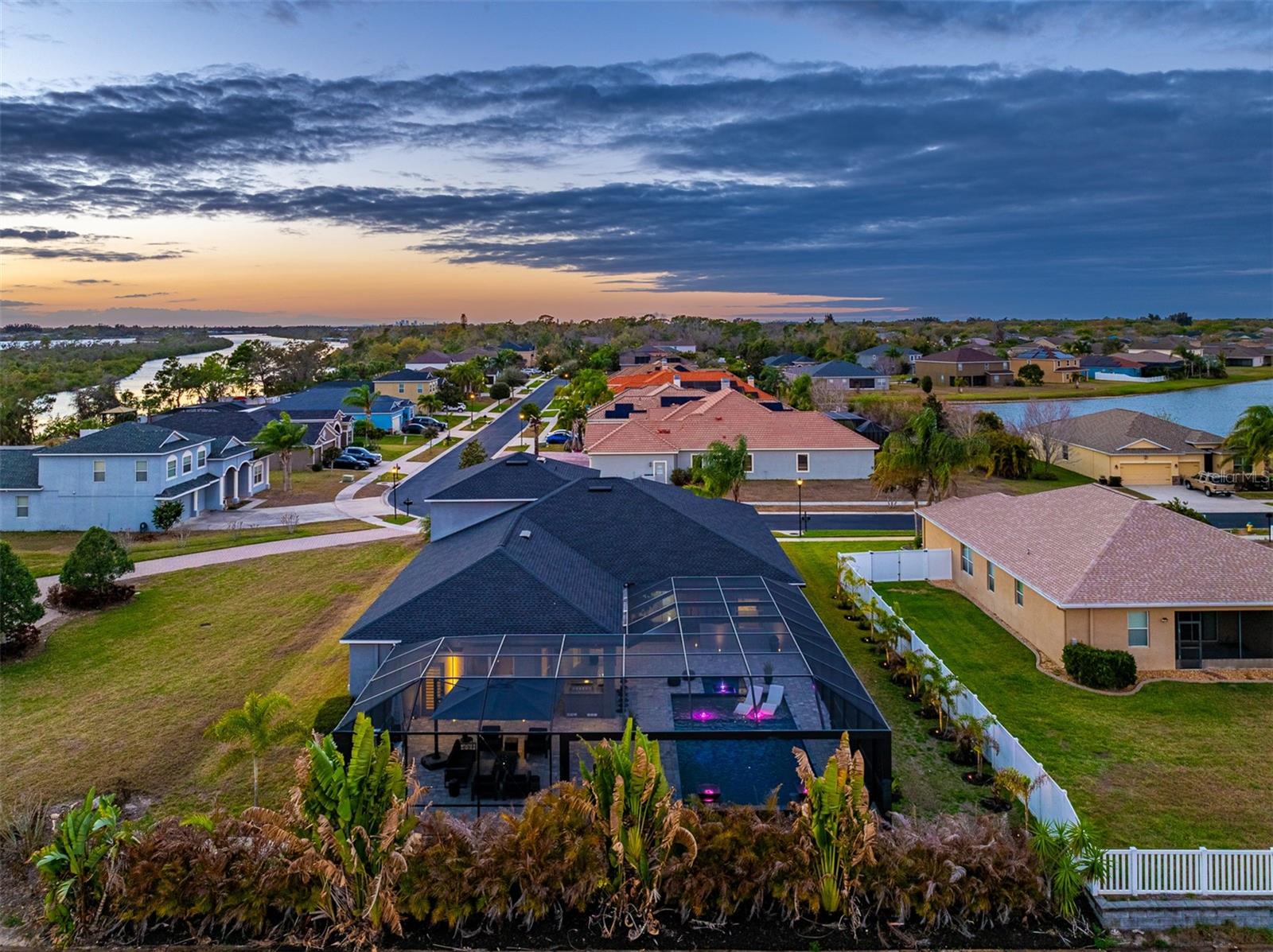 Luxury Pool/Lanai: Stunning screened-in custom pool and lanai with modern LED lighting, perfect for Florida outdoor living and sunset relaxation.