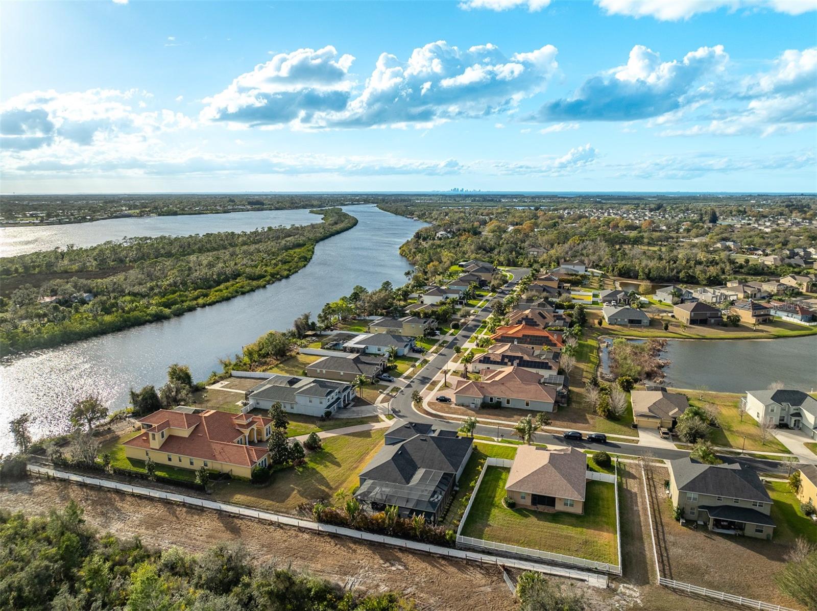 Panoramic aerial view of the neighborhood, waterways, and horizon.