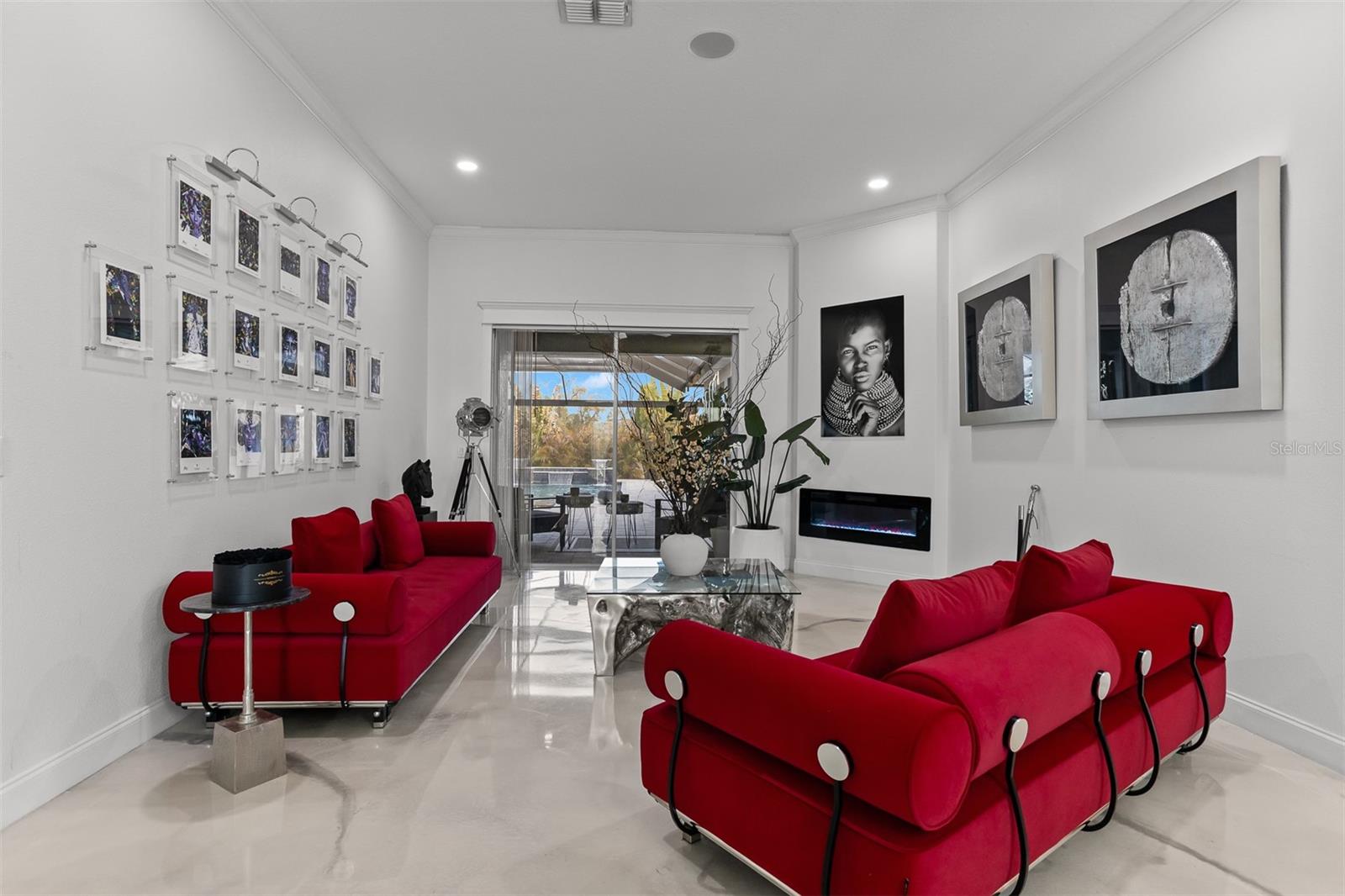 Designer living space featuring a modern linear electric fireplace and high-gloss flooring.