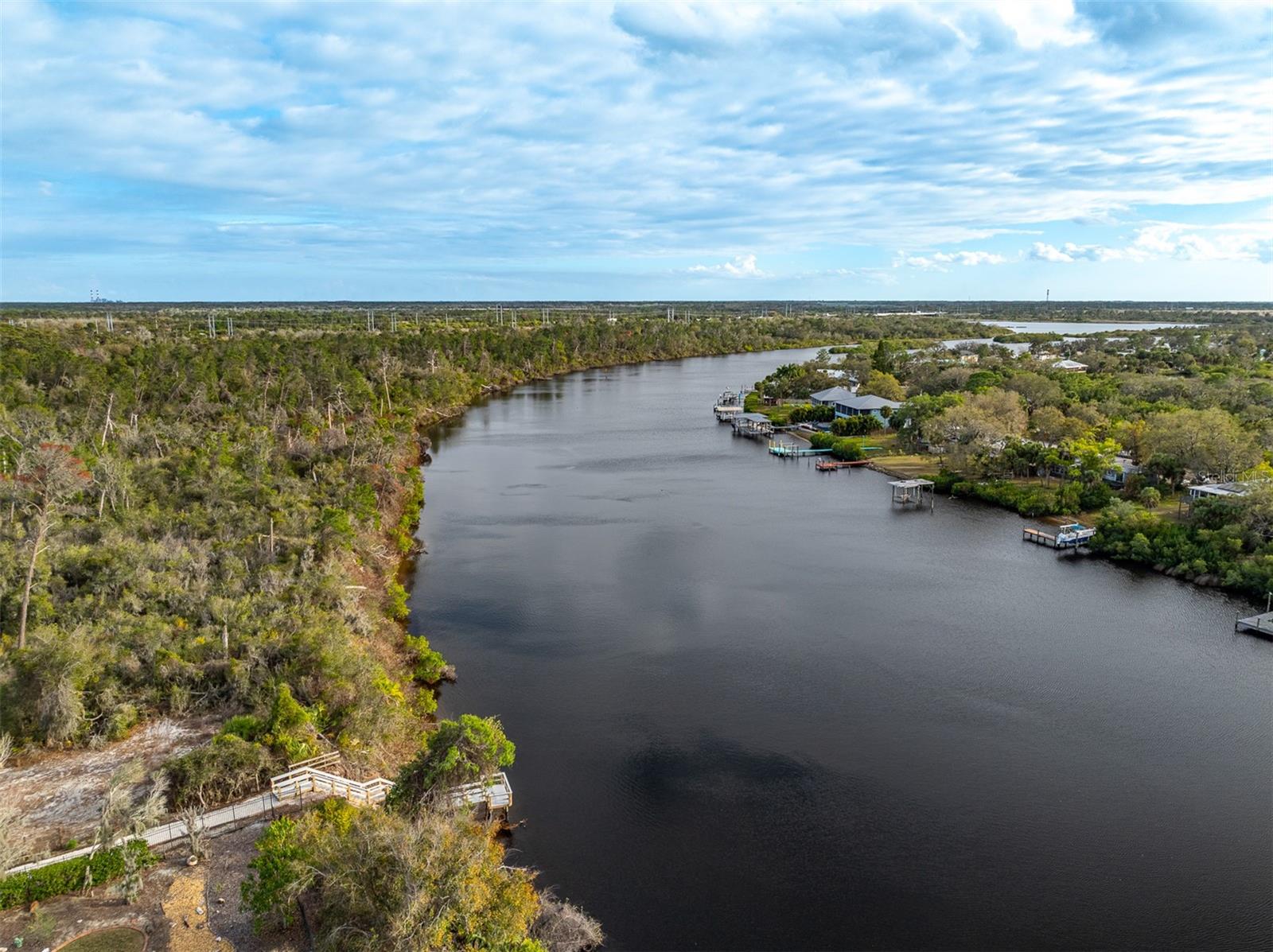 Aerial view of the lush greenery and private docks along the riverbank.