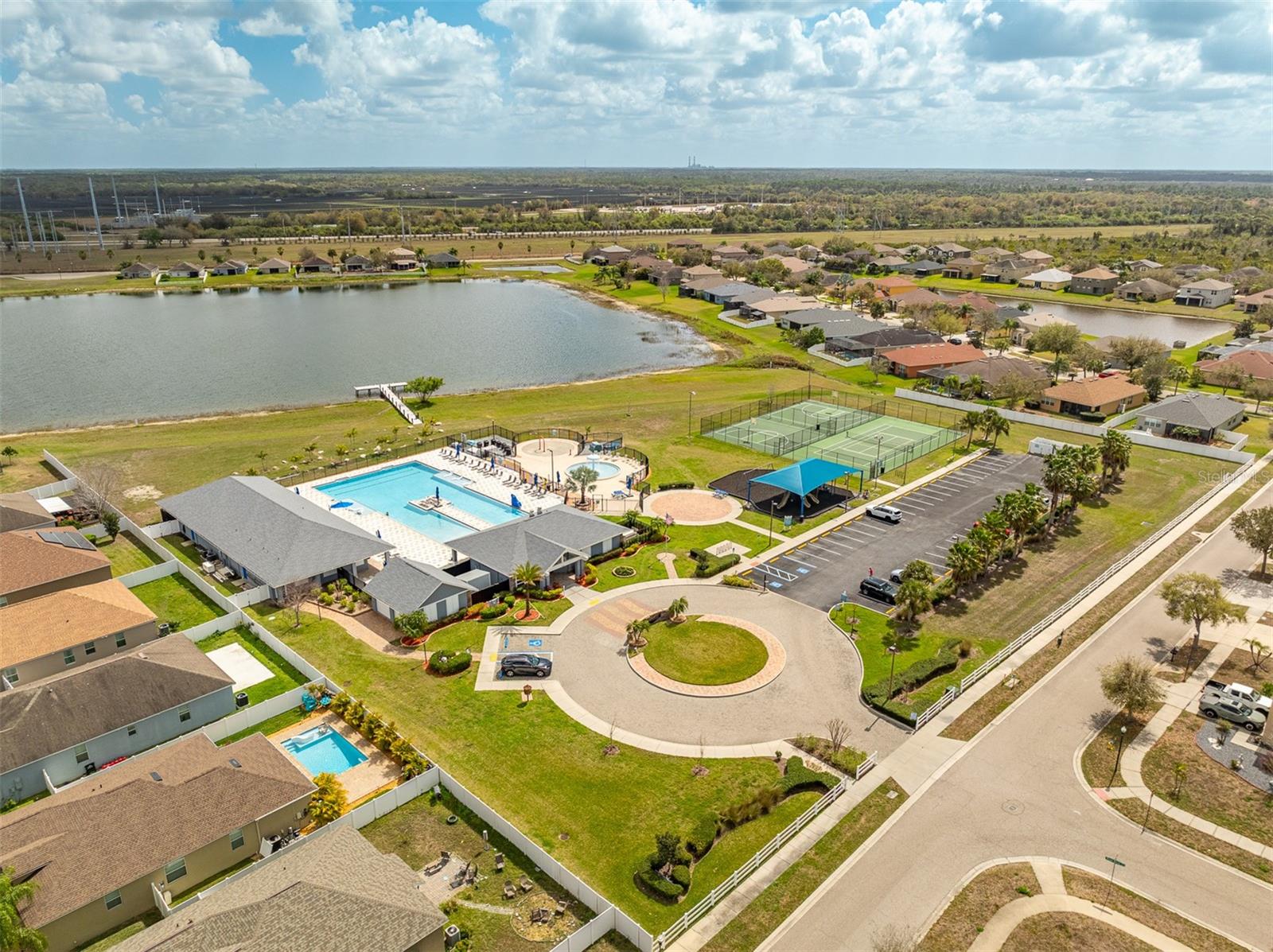 Aerial view of the River Bend community clubhouse, pool, and sports courts.