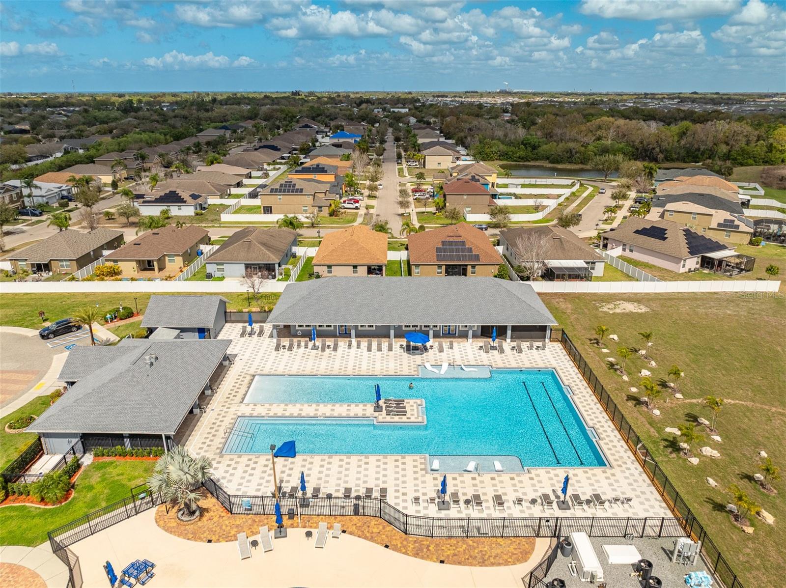 Top-down view of the expansive community pool area and clubhouse facilities.