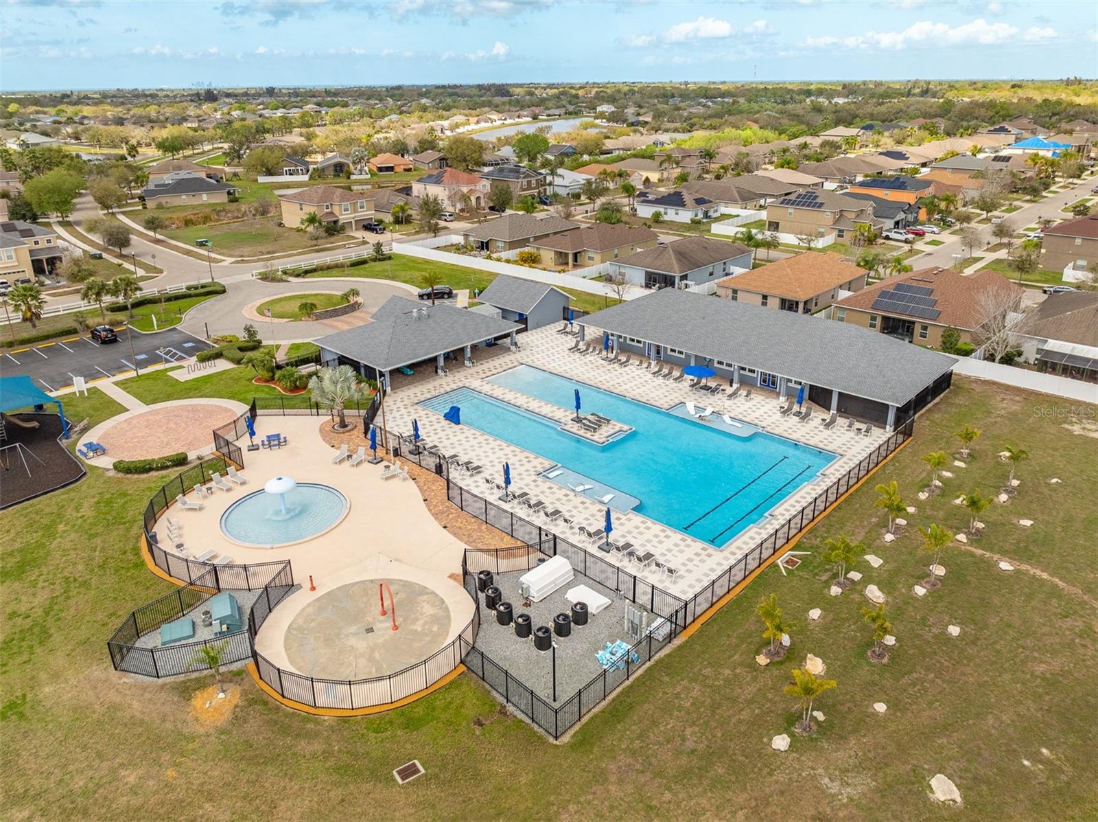 Detailed aerial of the kid-friendly splash pad and multi-lane lap pool.