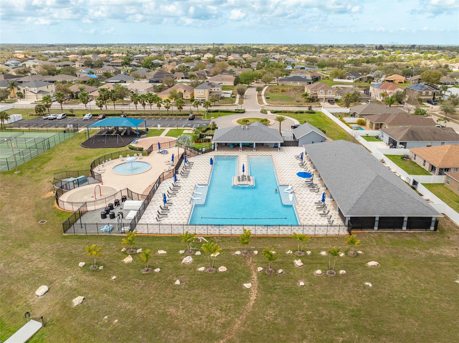 Direct aerial of the expansive resort-style pool and clubhouse facility.
