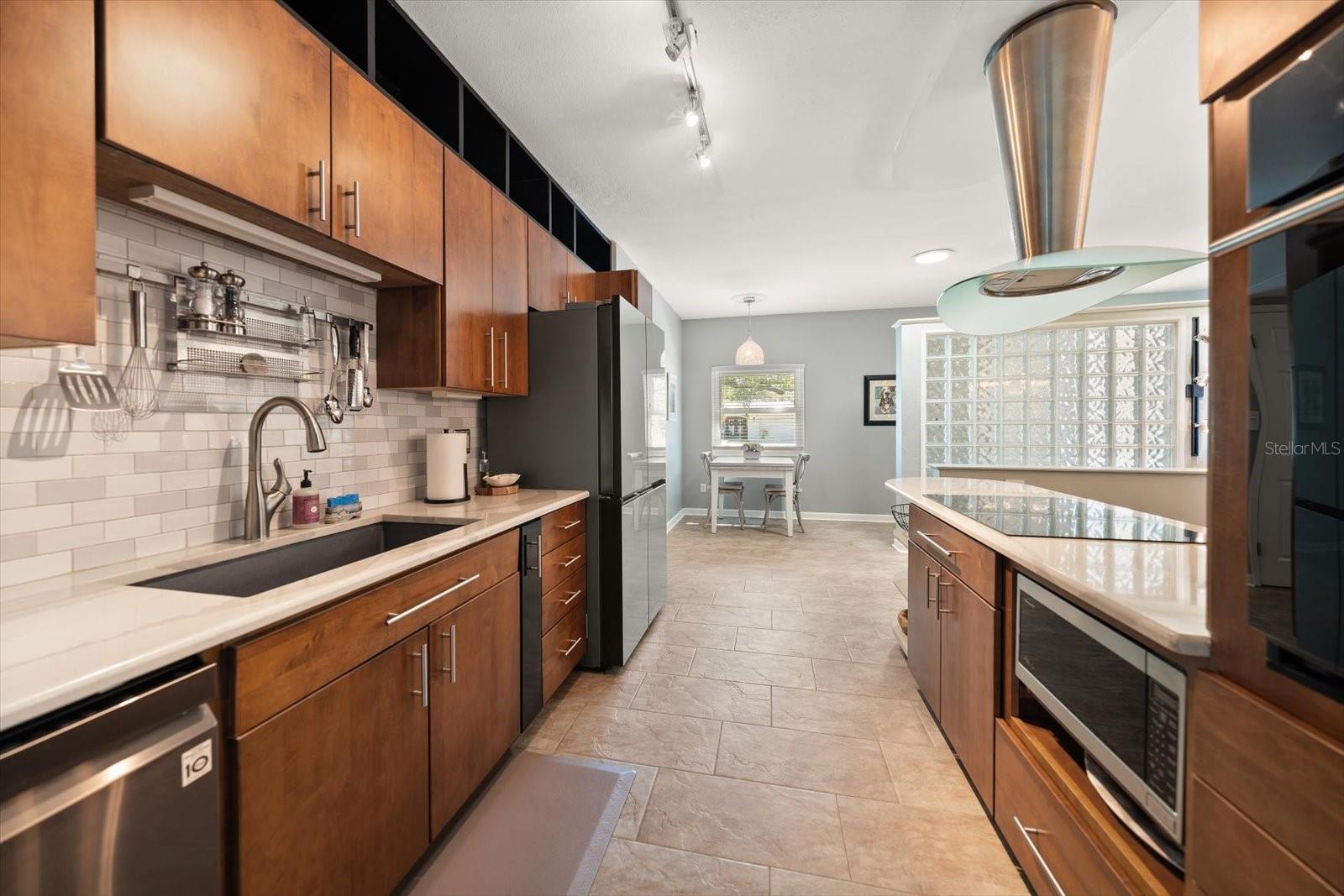 Warm modernism-balancing clean lines with integrated technology-this is a chef inspired kitchen!