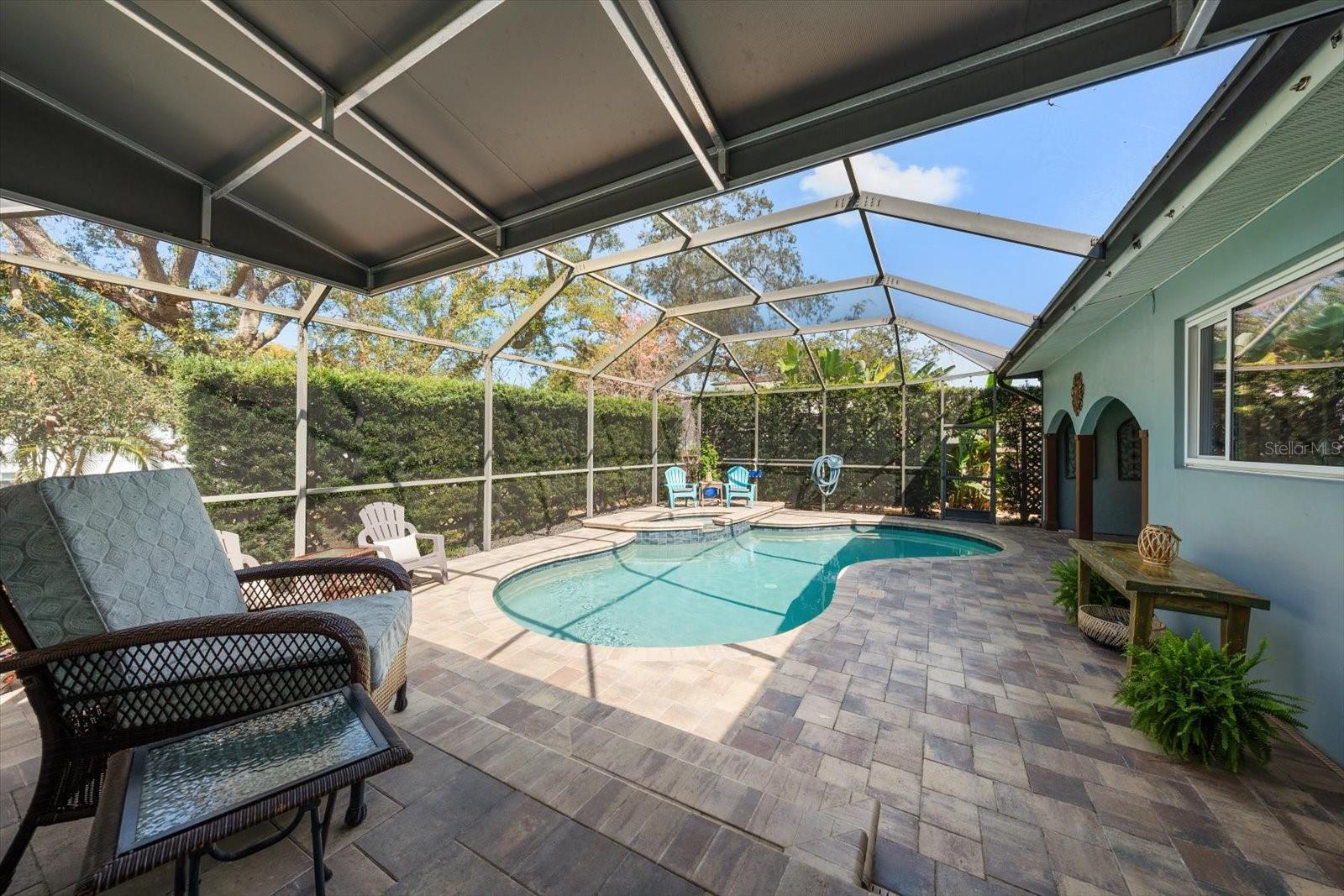 Pool and spa area surrounded by attractive brick pavers. Terraced area provides additional seating out of the sun.