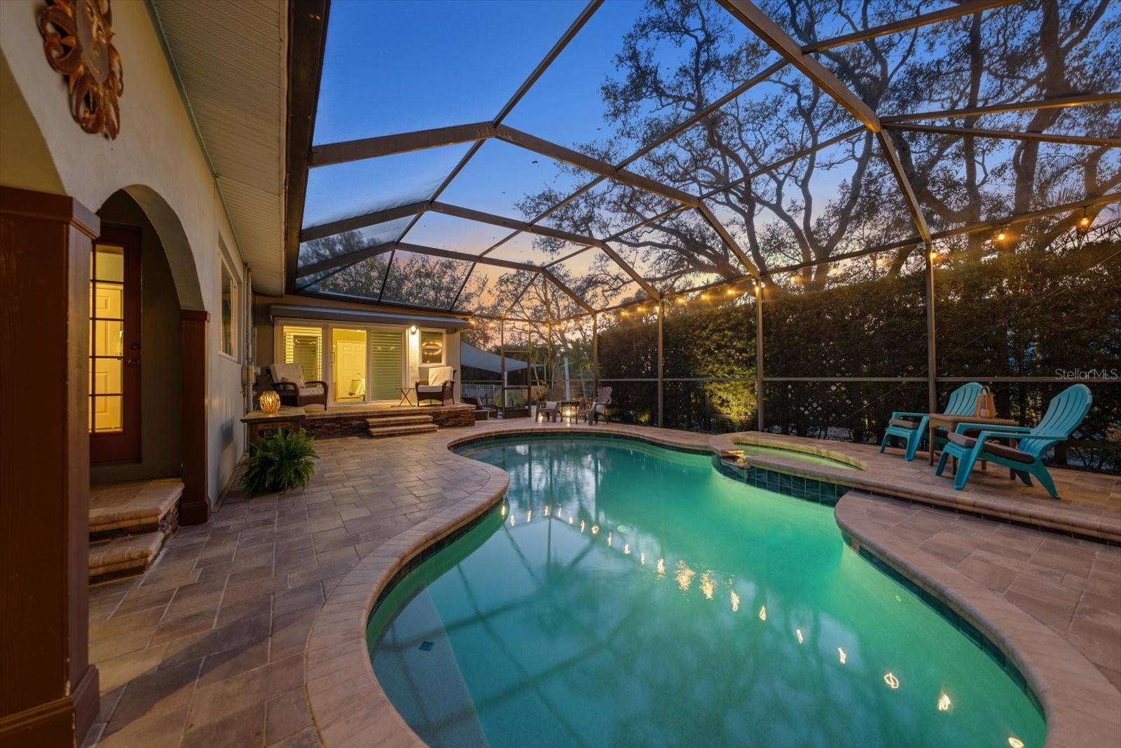 Pool and spa area flanked by covered patio, totally screened for all year enjoyment.