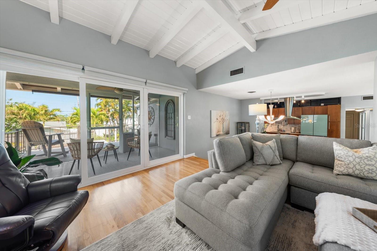 Family room with fine wood flooring, and a lovely screened porch for sunset views!