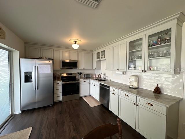 Kitchen with granite counters and designer backsplash