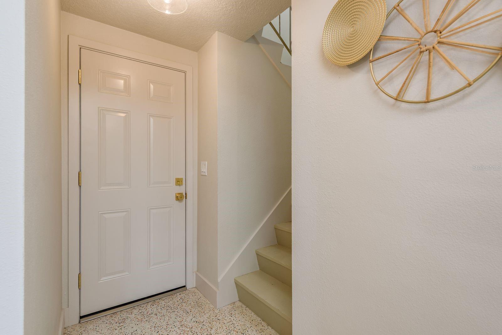 hallway, garage entry door and stairs to guest / in-law apartment