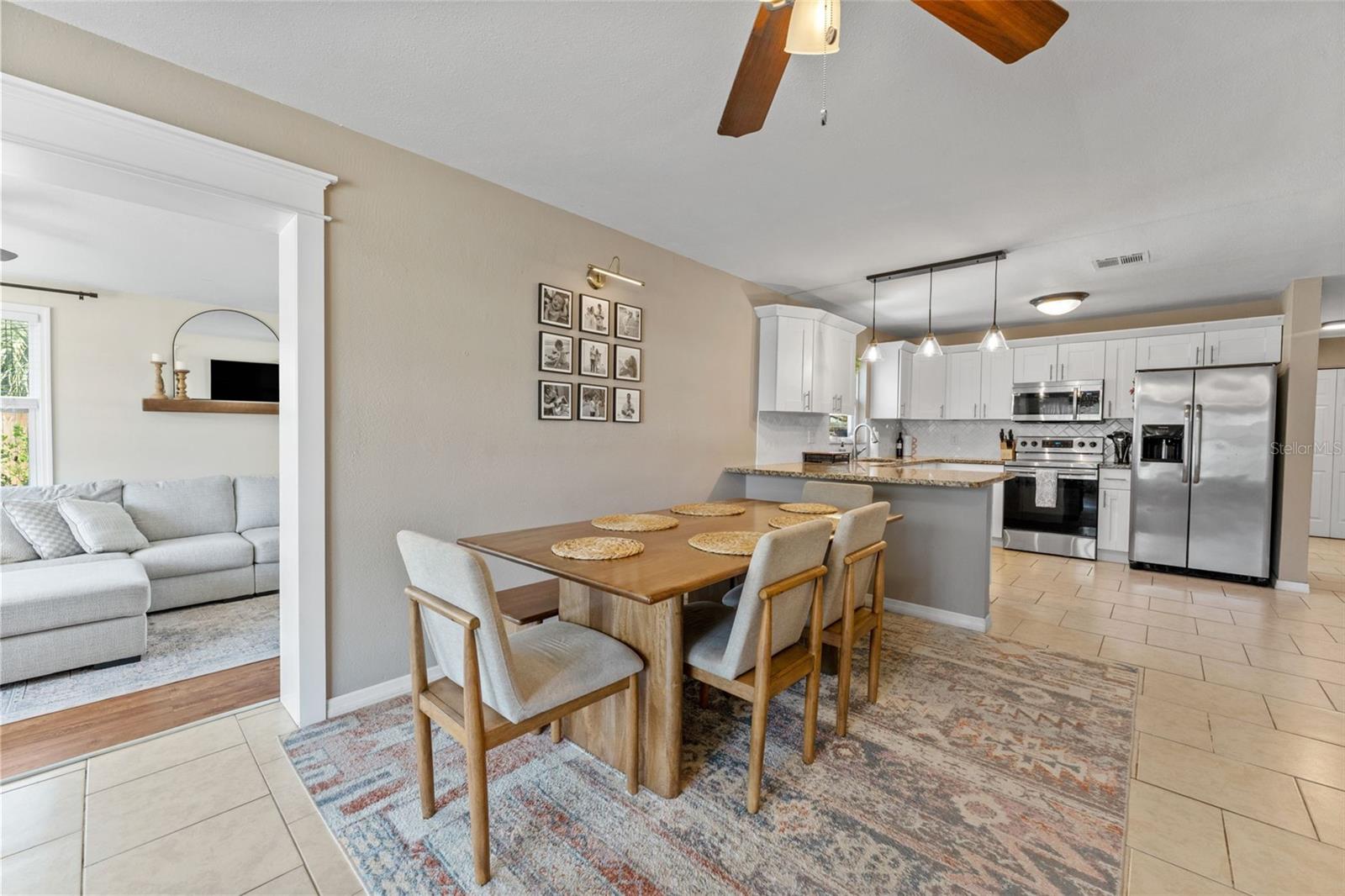 The open design allows the dining area and kitchen to flow together, creating a bright and welcoming place to gather.