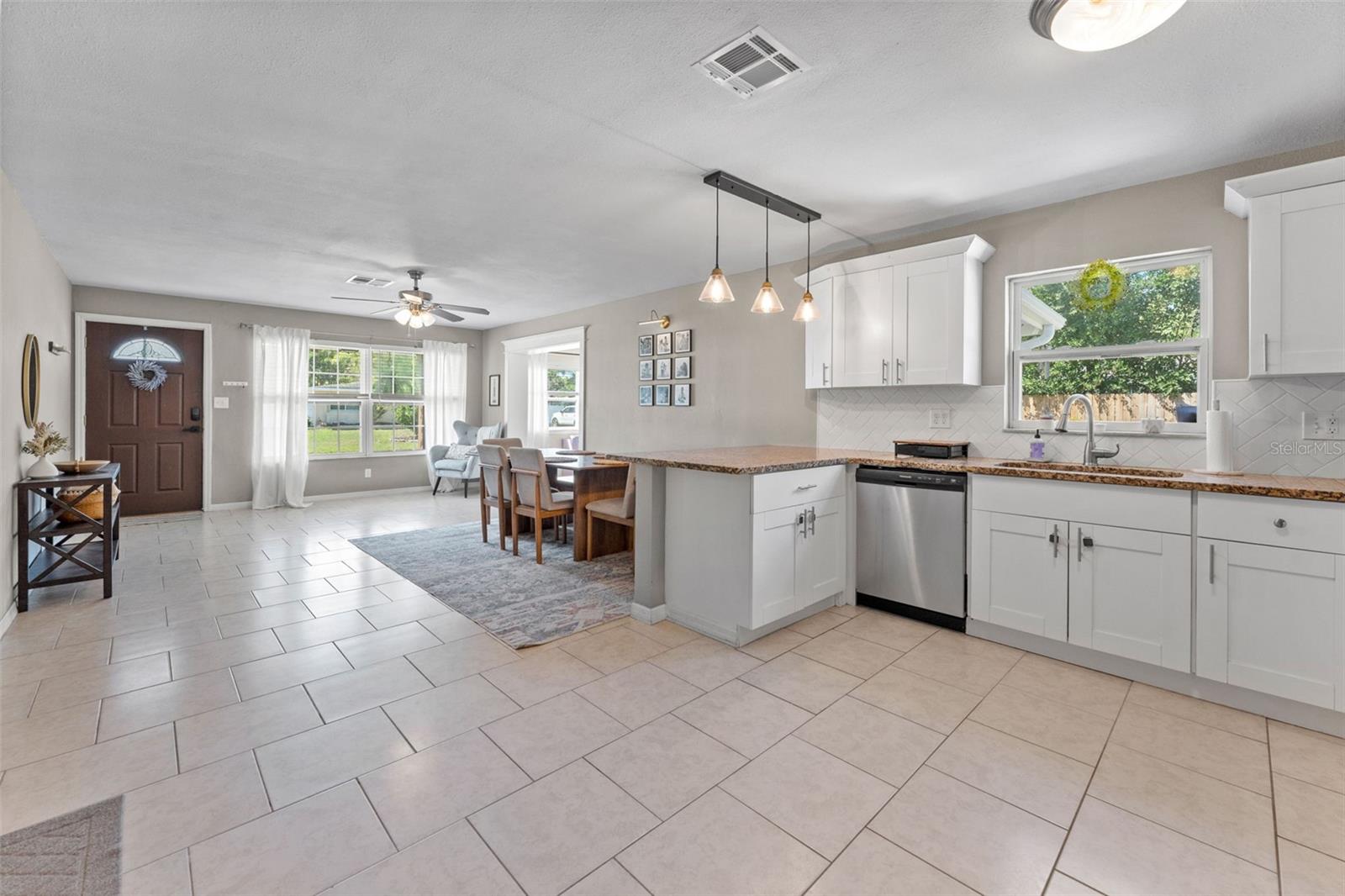 Open and inviting kitchen with classic shaker cabinets and polished granite countertops.