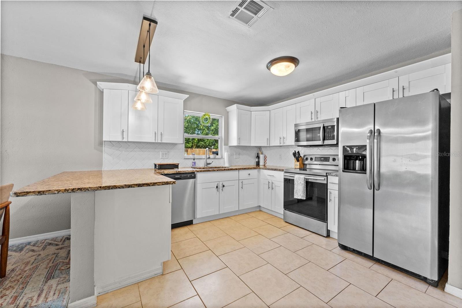 Modern kitchen with convenient bar seating—perfect for casual meals and entertaining guests.