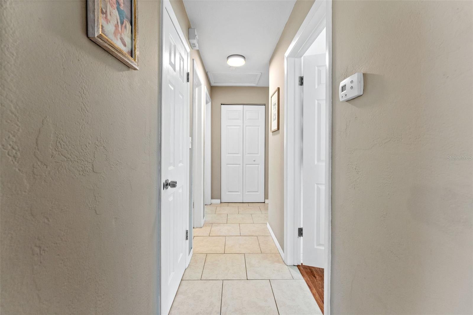 Bright hallway leading to bedrooms and bathrooms, with a clean layout and easy flow throughout the home.