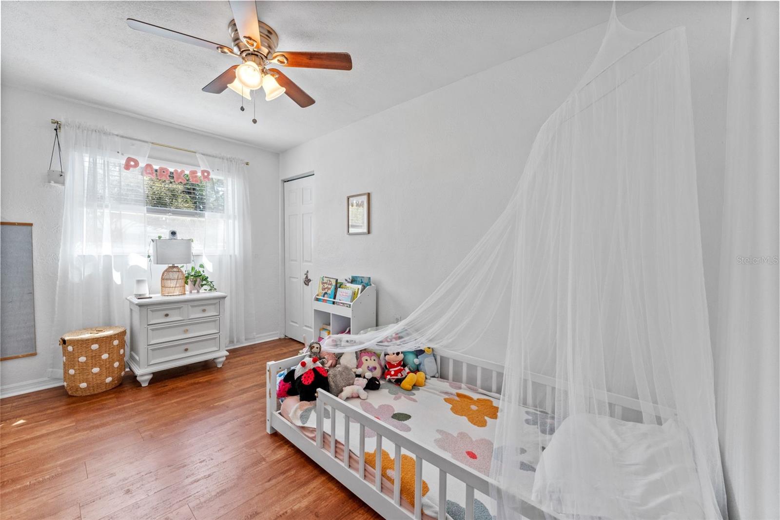 Bright second bedroom featuring luxury vinyl plank flooring and plenty of natural light.
