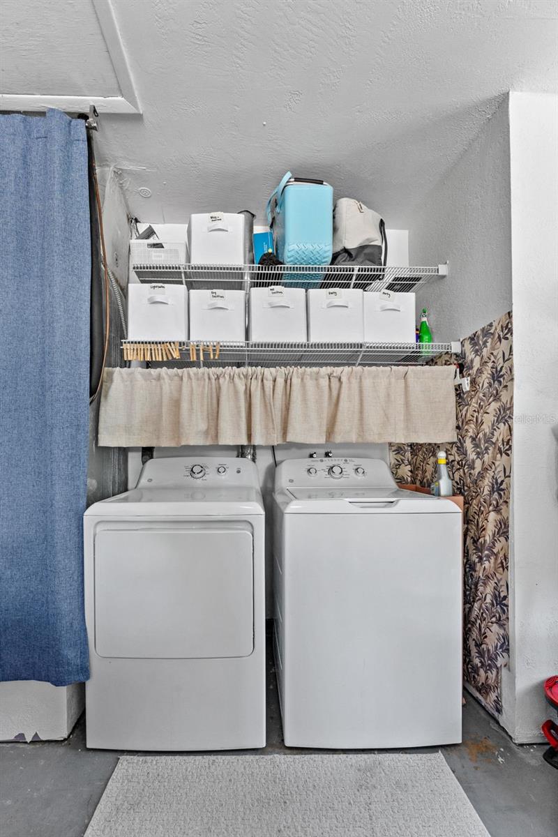 Convenient garage laundry area with washer and dryer included