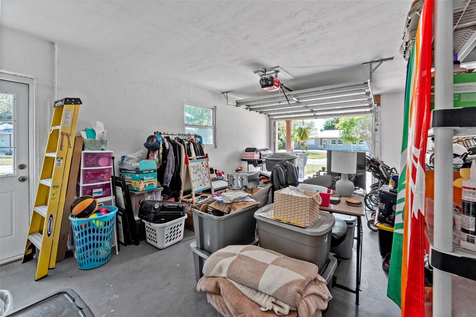 Garage equipped with a reinforced door featuring hurricane braces for added protection.