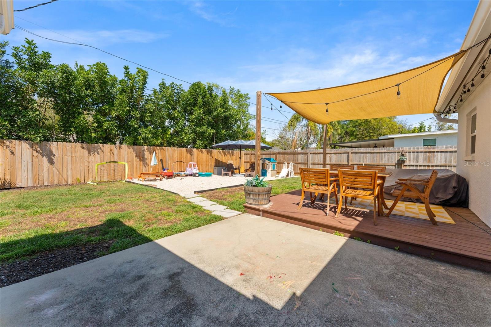 Backyard with concrete patio and wood deck