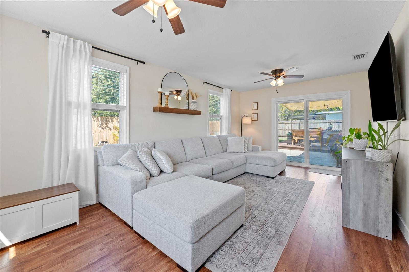 Enjoy a bright and spacious living room with sliding glass doors leading to the backyard, perfect for relaxing or entertaining.