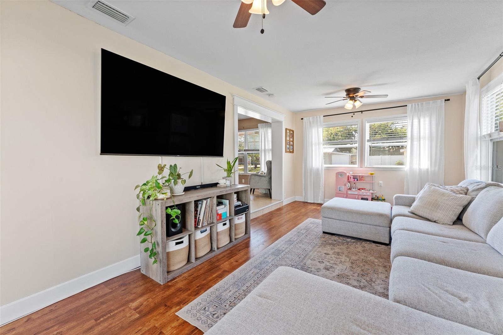 The luxury vinyl plank flooring in the living room adds both durability and a warm, cozy feel to the space.