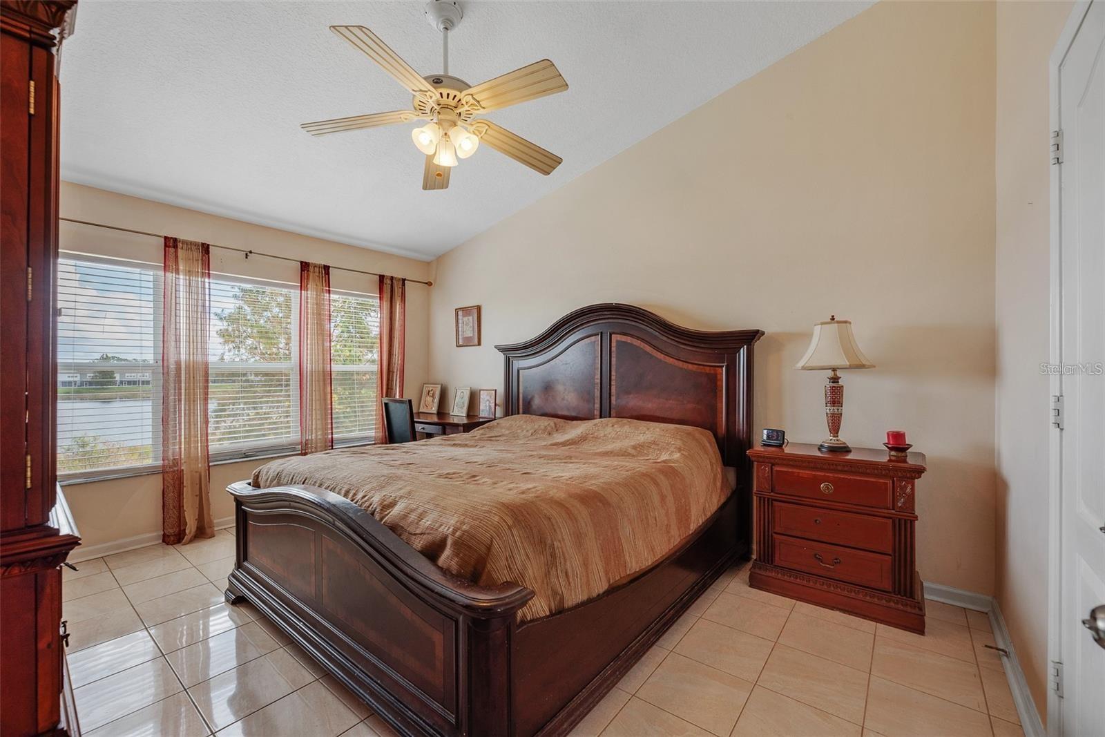 Large owners’ suite featuring breathtaking water views, walk-in closet, and en-suite bathroom