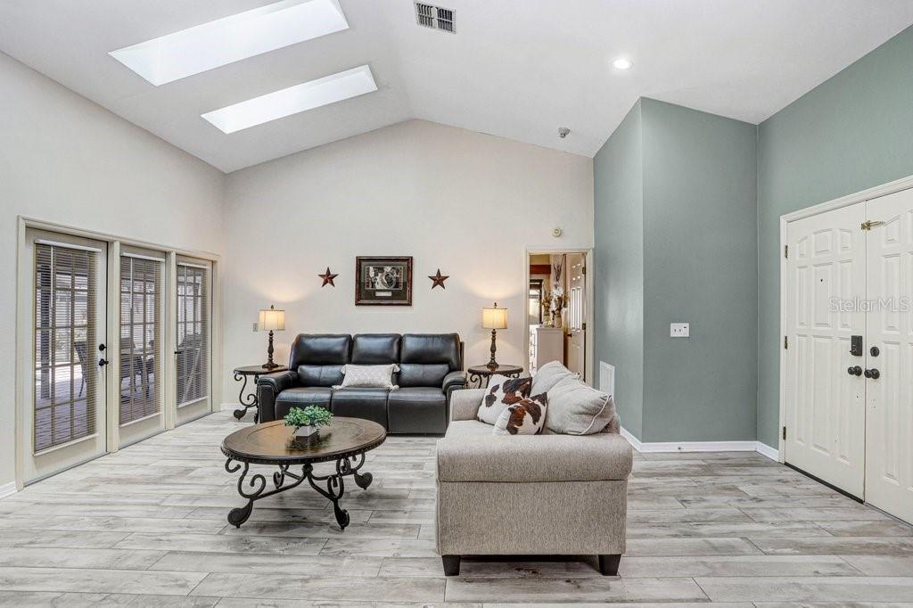 Vaulted Ceilings with skylights and wood look tile throughout