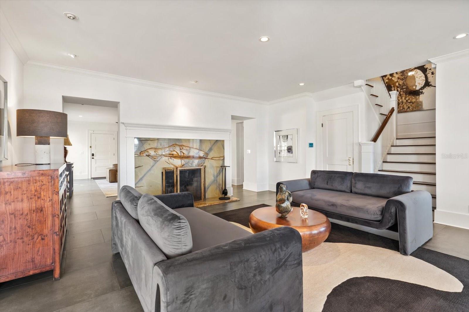 Living room with marble wood burning fireplace