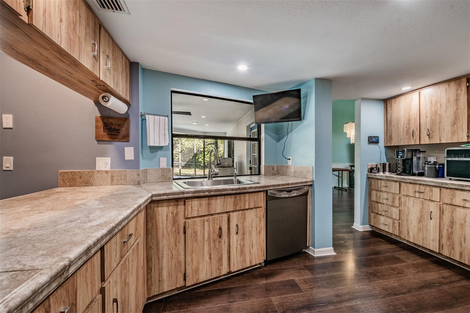 Open Kitchen with a Farmhouse Sink, Stainless Steel Appliances
