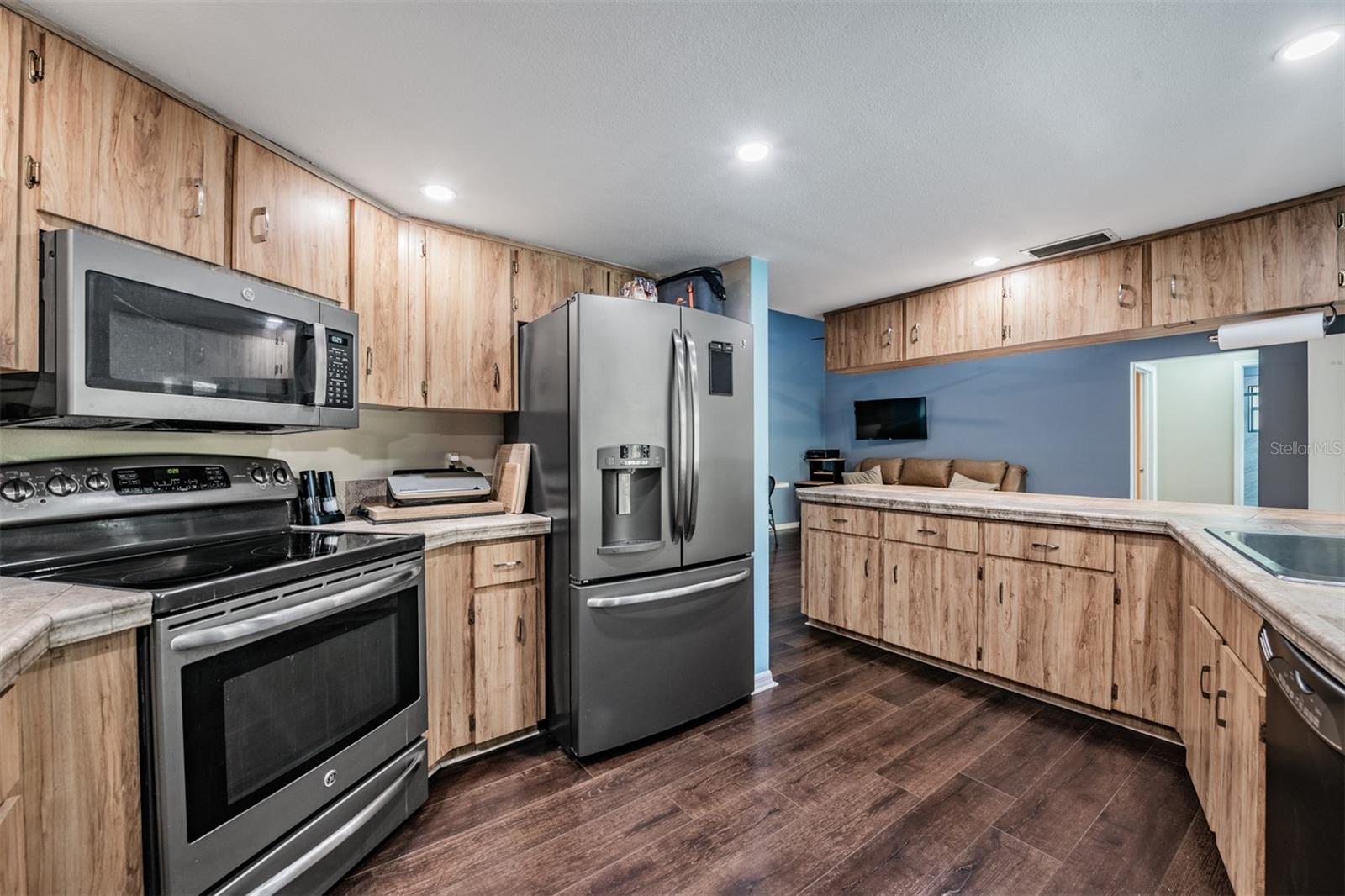 Open Kitchen with a Farmhouse Sink, Stainless Steel Appliances