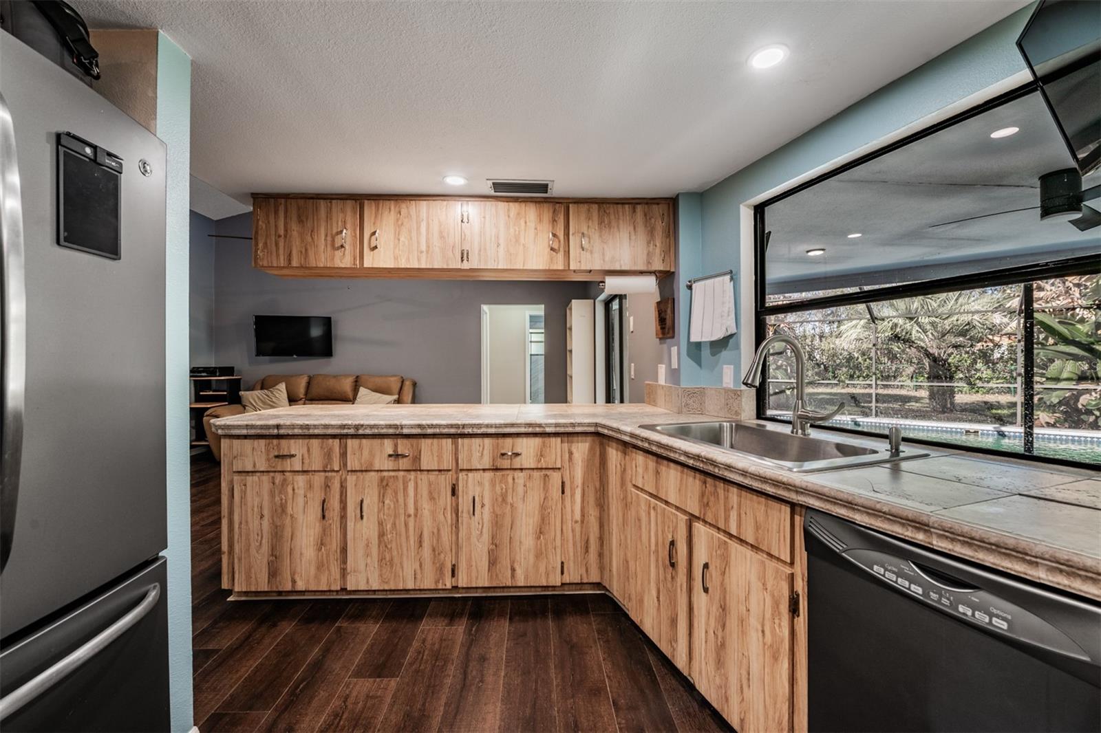 Kitchen with pass through window to the pool area, Farmhouse Sink, Stainless Steel Appliances