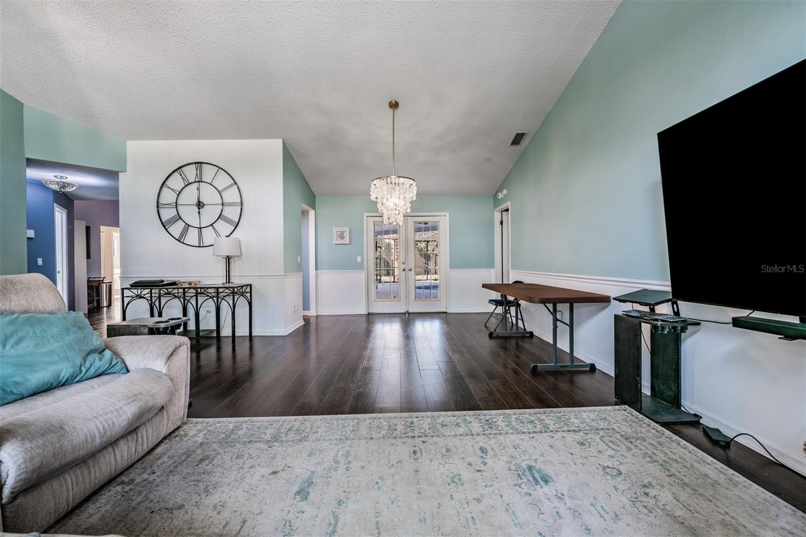 Entry way and Formal Family Room/Dining Room, and the French Doors lead to the Lanai/Pool.