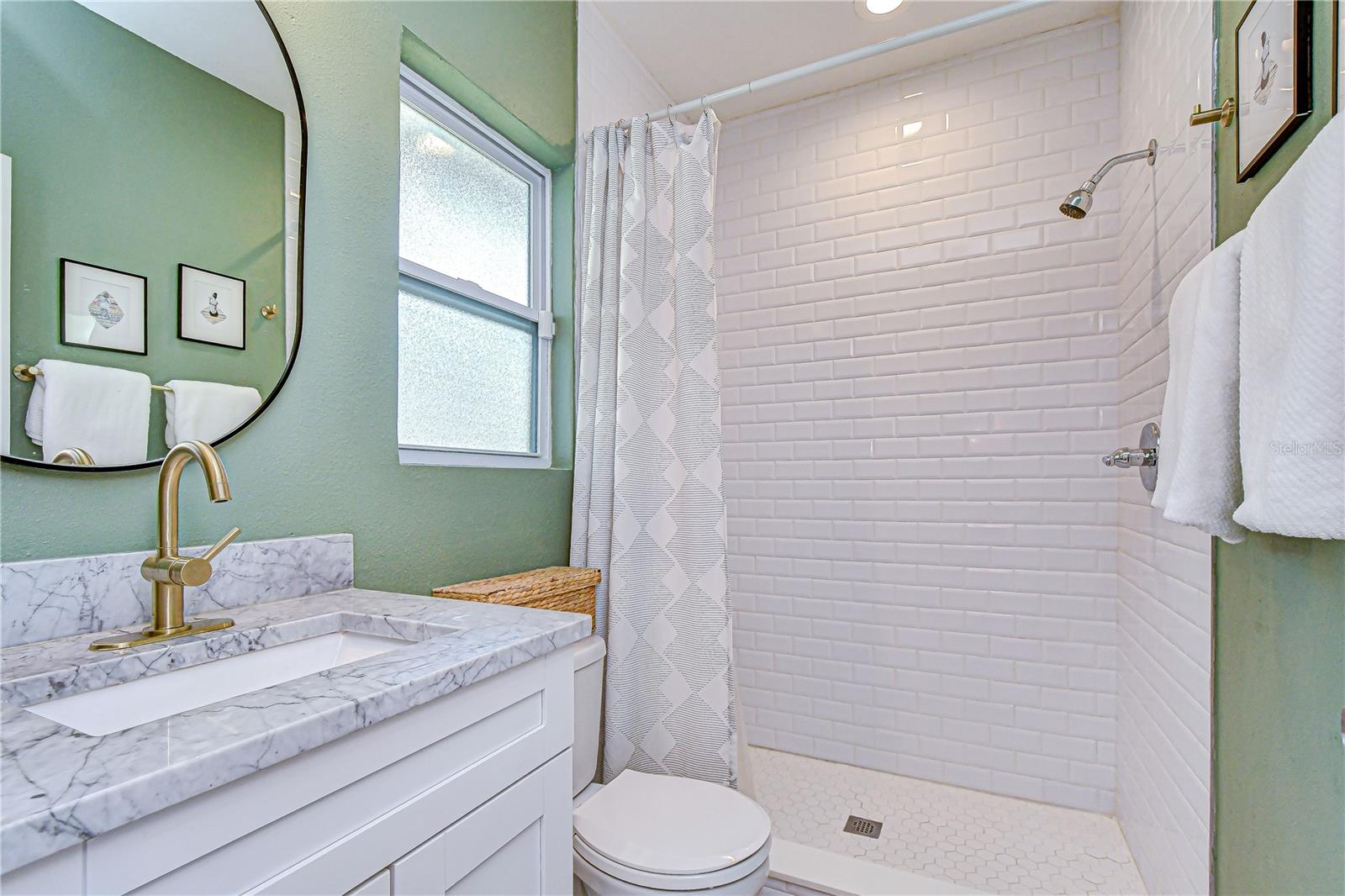 Remodeled en-suite bathroom offering modern comfort.