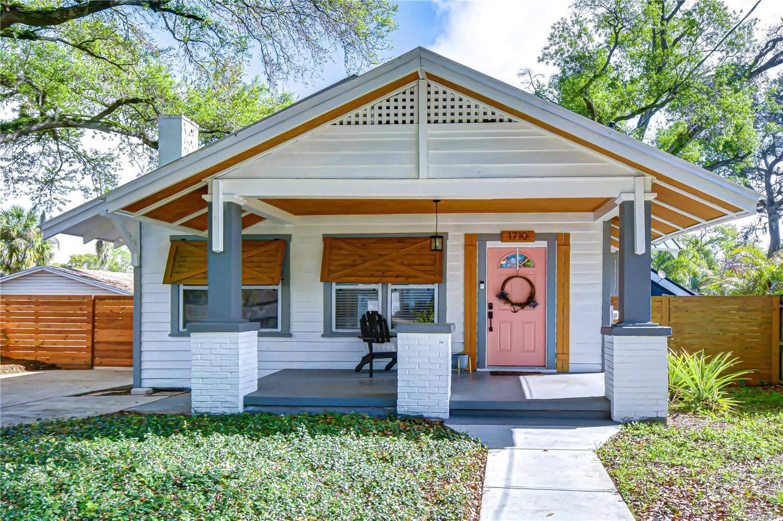 Updated landscaping enhancing the home’s curb appeal with mature trees and lush greenery.