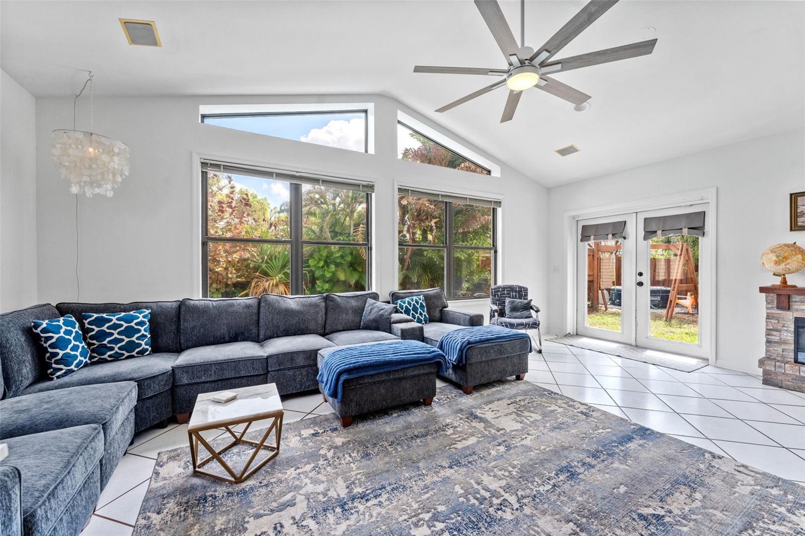 Great room with large windows and view of the pool