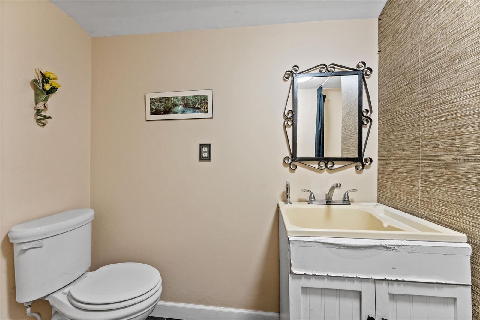 Half bath with washer. Attached to office space, accessible from kitchen or outside entrance.
