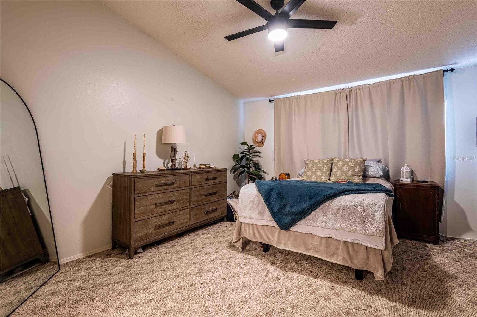 Primary bedroom with vaulted ceilings.